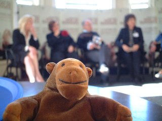 Mr Monkey in front of a panel of authors