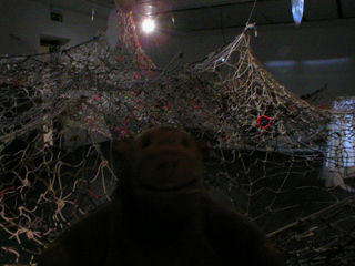 Mr Monkey looking at netting hanging from the CAC's ceiling
