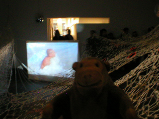 Mr Monkey watching the video in Memento