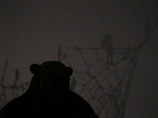 Mr Monkey looking at the the shadows of the cut-out figures