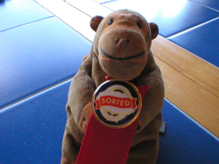 Mr Monkey holding his Sorted badge