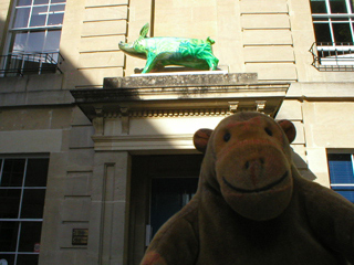 Mr Monkey looking at one of King Bladud's pigs over a doorway in Bath
