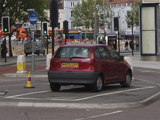 A car parked on a small traffic island in Bristol