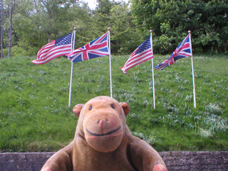 Mr Monkey looking at flags outside the Museum