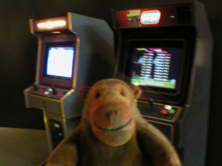 Mr Monkey looking at arcade game booths