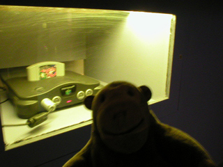 Mr Monkey looking at a Nintendo 64