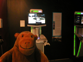 Mr Monkey looking at an XBox playing Grand Theft Auto