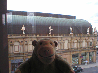 Mr Monkey looking at the statues on Victoria shopping centre