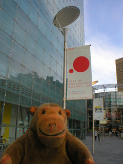 Mr Monkey looking at the banners outside Urbis