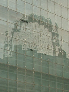 The Wheel of Manchester reflected on the side of Urbis