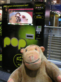 Mr Monkey looking at the DVD vending machines at Piccadilly station