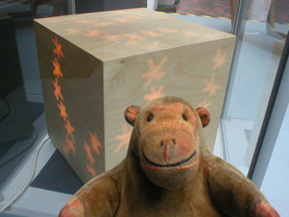 Mr Monkey looking at a light box by Jane Blease