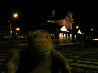 Mr Monkey looking at the De Haan Aan Zee tramstop at night