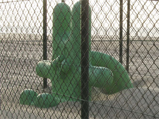 A rabbit-shaped slide surrounded with high fencing