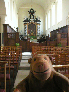 Mr Monkey looking up the nave of the church of the Beguinage