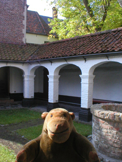 Mr Monkey looking across the beguine's courtyard