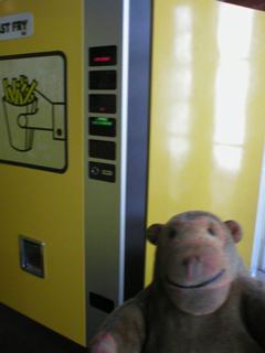 Mr Monkey looking at a chip dispensing machine