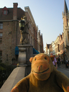 Mr Monkey looking at the statue of St John Nepomucene on the Nepomucene bridge