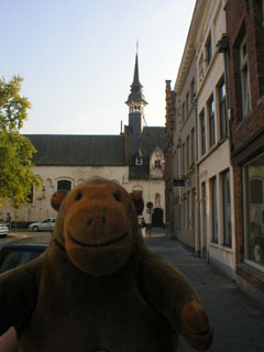 Mr Monkey walking down a quiet street in Bruges