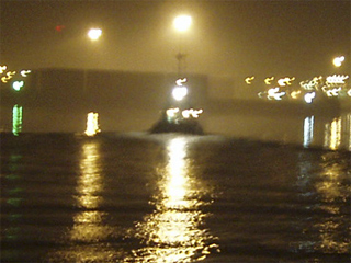 A fishing boat sailing into Ostende at night