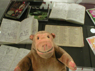 Mr Monkey looking at Junior Disprol's rhyme books