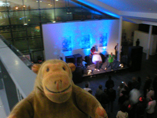 Mr Monkey looking down on a band playing at Urbis