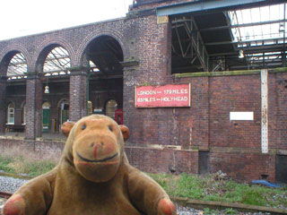 Mr Monkey looking at the London - Holyhead sign at Chester