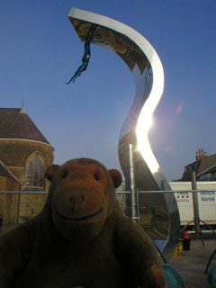 Mr Monkey looking at the Wave sculpture in St Johns