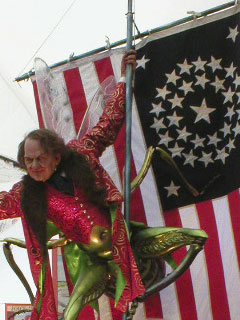 The P.T. Barnum - insect hybrid swinging in front of a flag