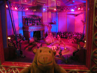 Mr Monkey looking at a model of a Piper's Insect Circus performance