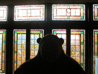 Mr Monkey looking at stained glass behind the upper circle
