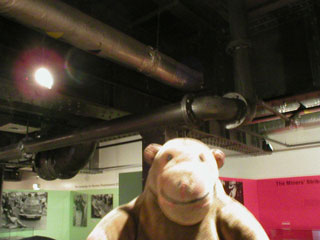 Mr Monkey looking at the pipes under the coal store
