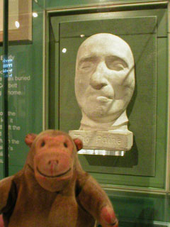 Mr Monkey looking at Thomas Paine's deathmask