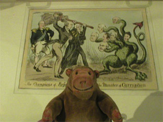Mr Monkey looking at a print celebrating the Great Reform Act