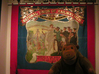 Mr Monkey looking at the Railwaymen's union banner