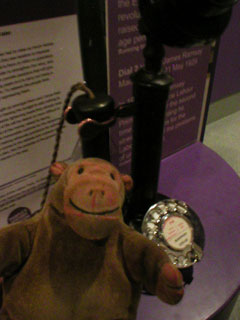 Mr Monkey listening on a vintage telephone