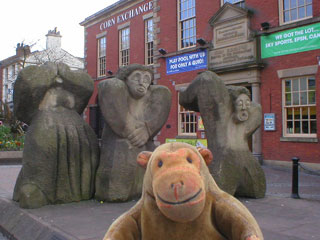 Mr Monkey looking at the statue of the workers being shot