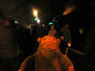 Mr Monkey watching people gathered around the locomotive at Stockport