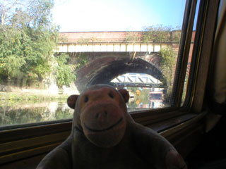 Mr Monkey looking at the bridge carrying the railway line from Deansgate