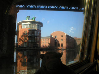 Mr Monkey looking through an arch of the viaduct to Salford