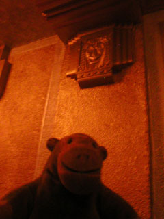 Mr Monkey examining an 'Egyptian' face on the wall of the Plaza