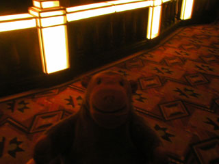 Mr Monkey looking at the orchestra balustrade