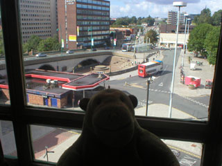 Mr Monkey looking a Mersey Square from the projection room of the Plaza