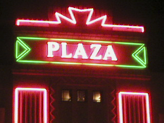 The neon sign on the front of the Plaza cinema