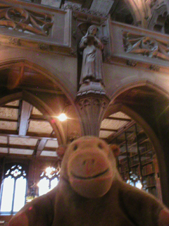 Mr Monkey looking at the statue of Caxton
