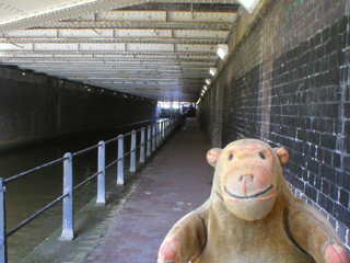 Mr Monkey looking through the Deansgate tunnel