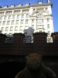 Mr Monkey looking up at St James's Buildings on Oxford Street