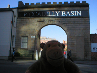 Mr Monkey looking at the entrance arch of the Piccadilly Canal Basin