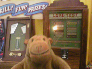 Mr Monkey looking at vintage coin-in-the-slot machines