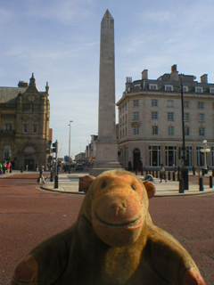 Mr Monkey looking at the central obelisk of Southport war memorial